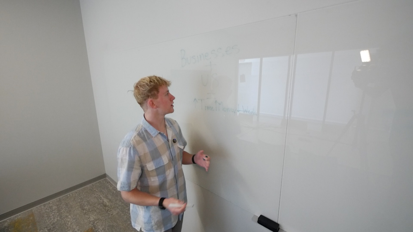 Liam Bloedow, Vaelro co-founder, explaining a system at a whiteboard